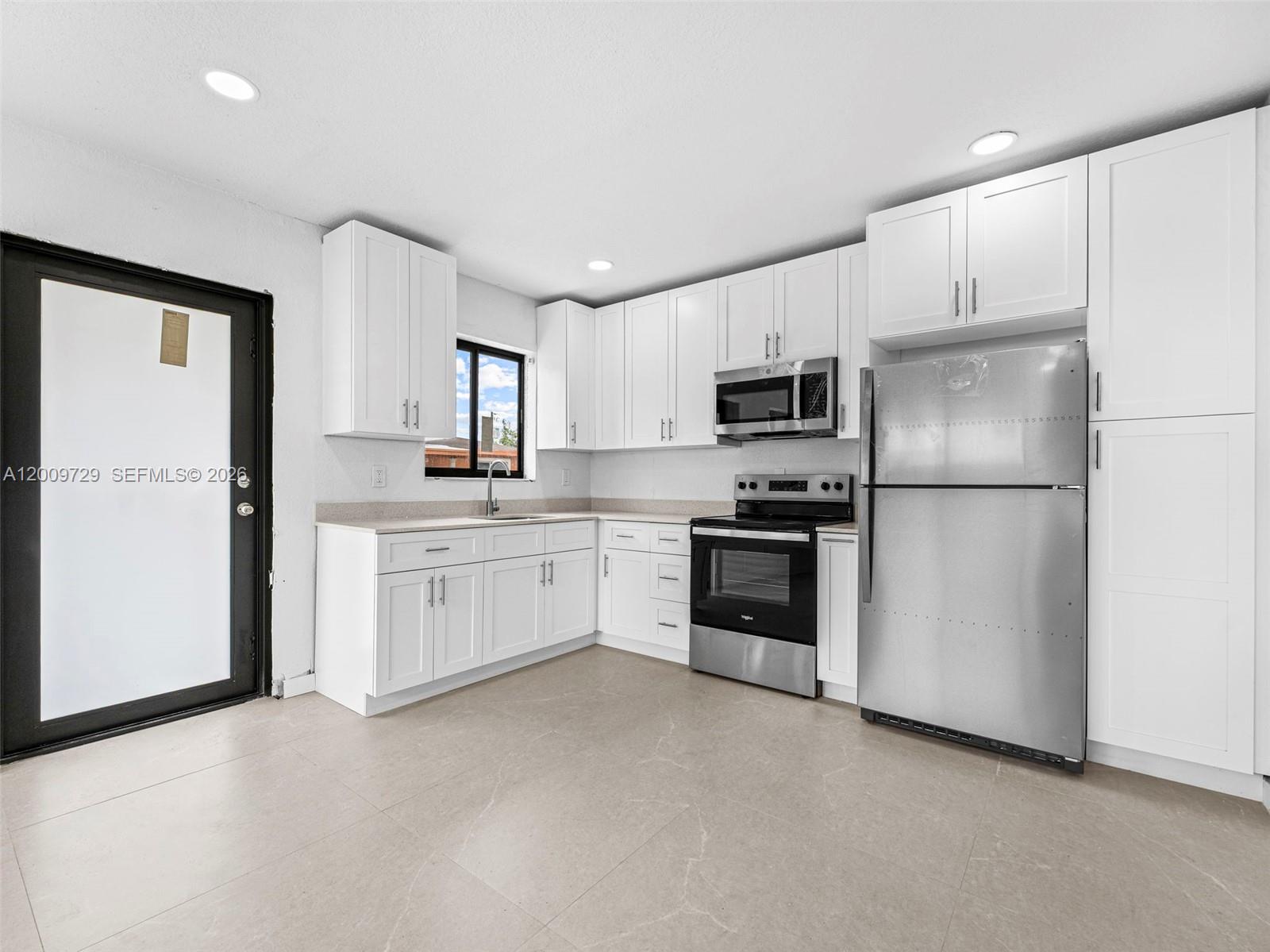 1370 West 29th Street, Unit B Hialeah, FL 33012 - Photo 10 of 15 a kitchen with a refrigerator stove and microwave