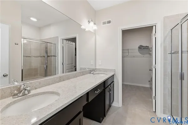 a bathroom with a glass shower door