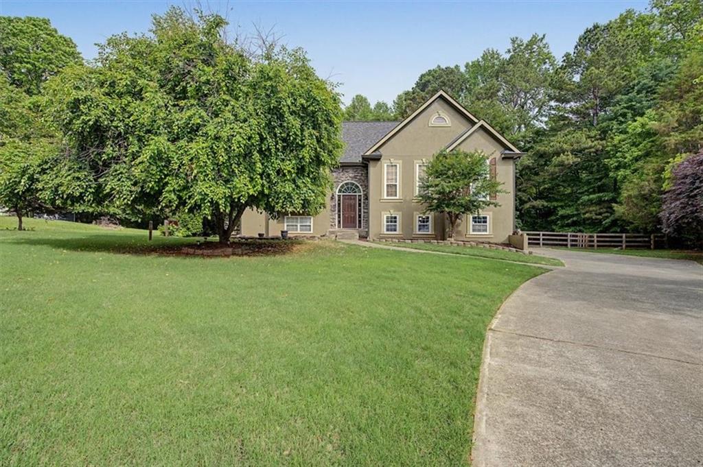 409 Windsor Way Canton, GA 30115 - Photo 2 of 51 a front view of house with yard and green space