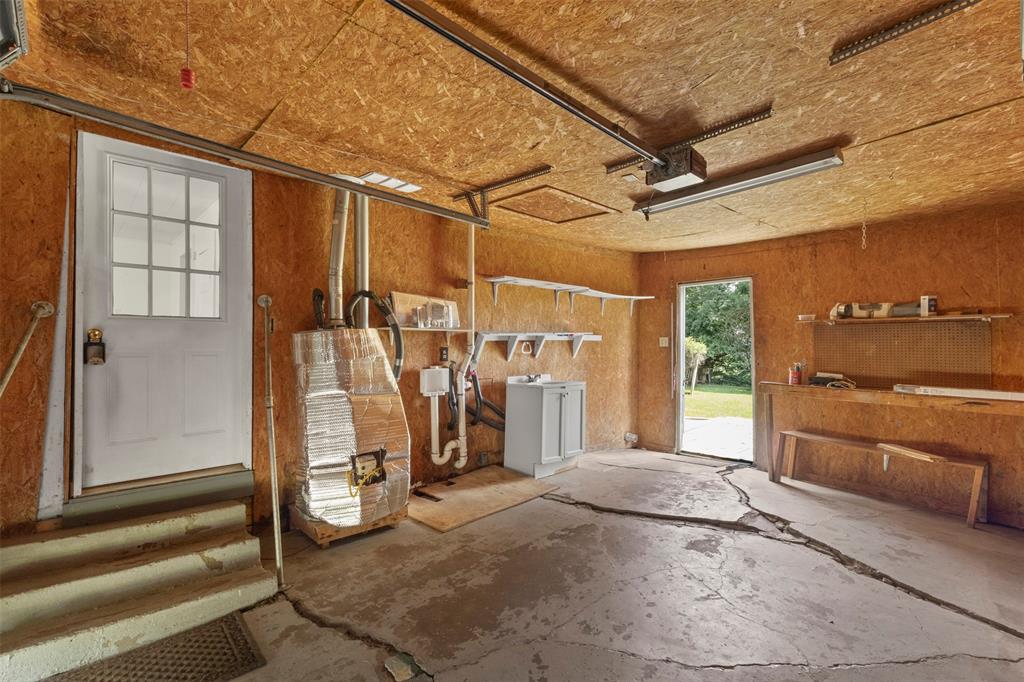 829 West 9th Street Bonham, TX 75418 - Photo 26 of 30 Concrete floor garage with exposed wood-finish walls and ceiling