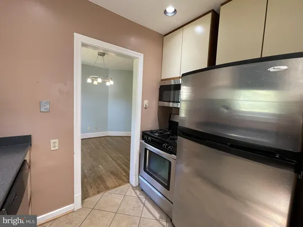 a kitchen with granite countertop a stove and a refrigerator