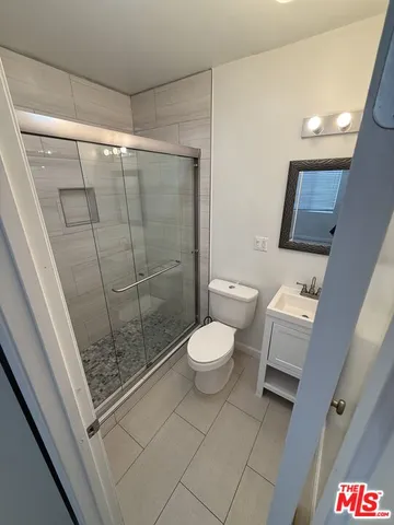a bathroom with a toilet and a shower
