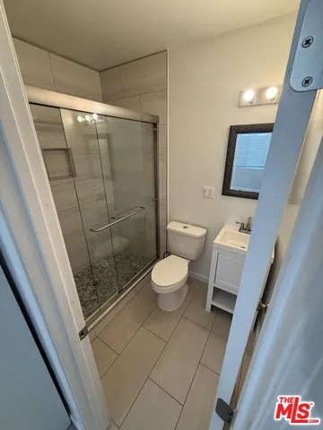 a bathroom with a toilet and a shower