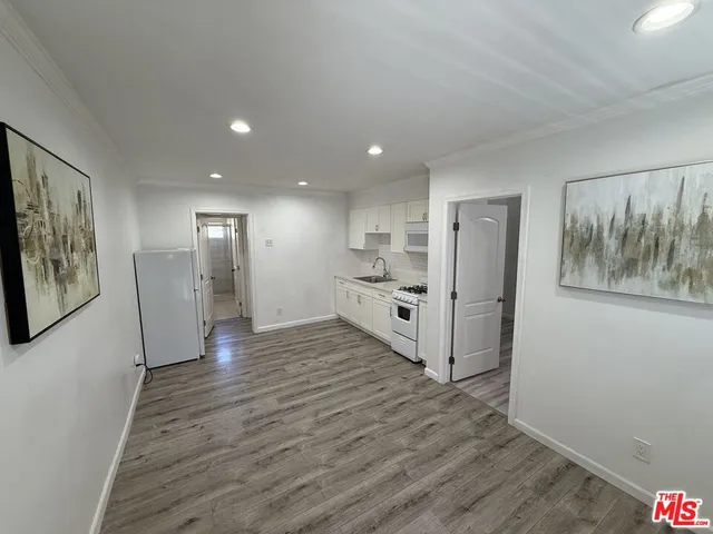 a view of a kitchen with wooden floor and entrance