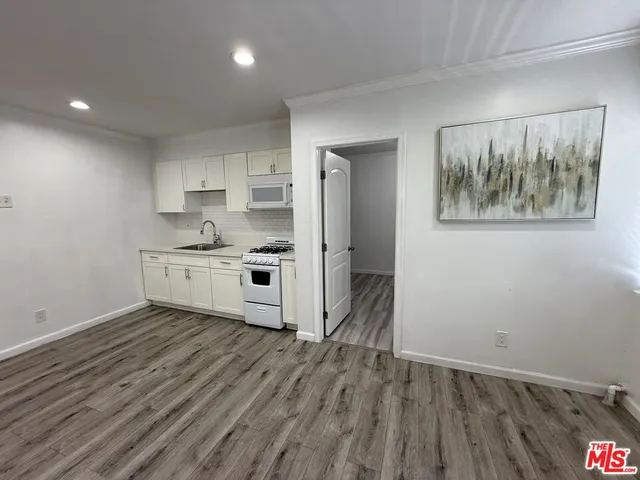 a view of kitchen with wooden floor and window