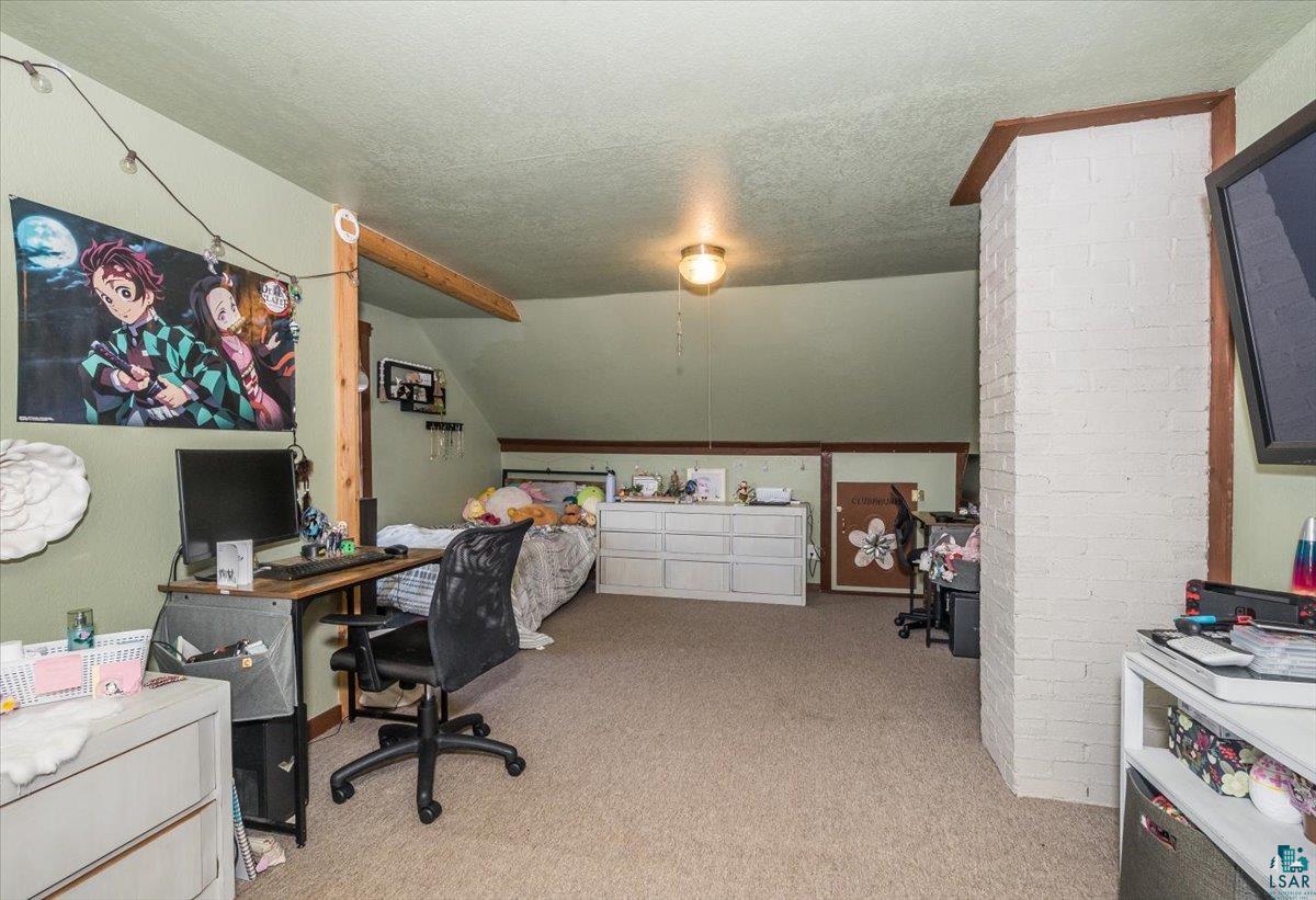 7702 East Rockmont Road Poplar, WI 54864 - Photo 15 of 22 Carpeted office with vaulted ceiling and a textured ceiling