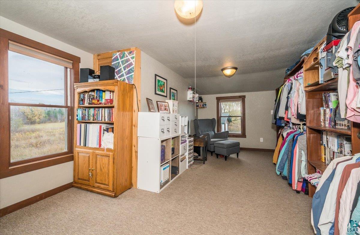 7702 East Rockmont Road Poplar, WI 54864 - Photo 16 of 22 Walk in closet with light carpet