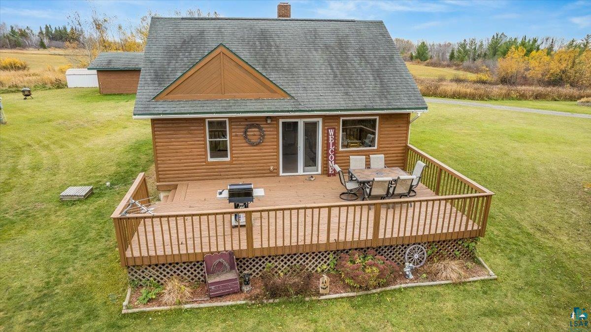 7702 East Rockmont Road Poplar, WI 54864 - Photo 18 of 22 Rear view of property with a wooden deck and a lawn