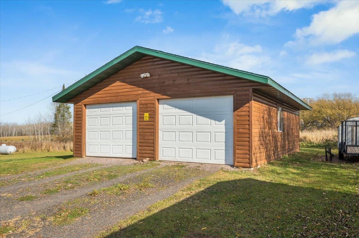 7702 East Rockmont Road Poplar, WI 54864 - Photo 20 of 22 Garage with a yard