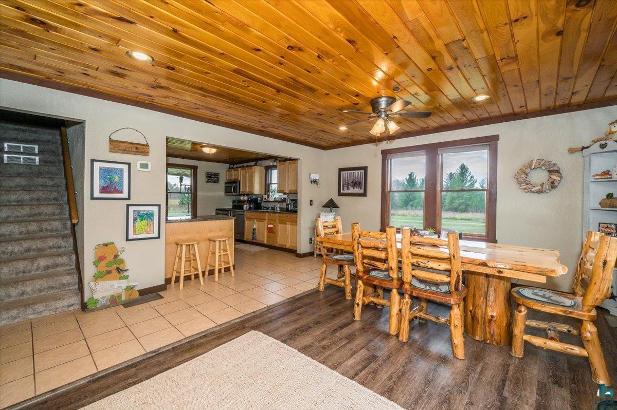 7702 East Rockmont Road Poplar, WI 54864 - Photo 8 of 22 Dining area with ceiling fan, light wood-type flooring, a healthy amount of sunlight, and wooden ceiling