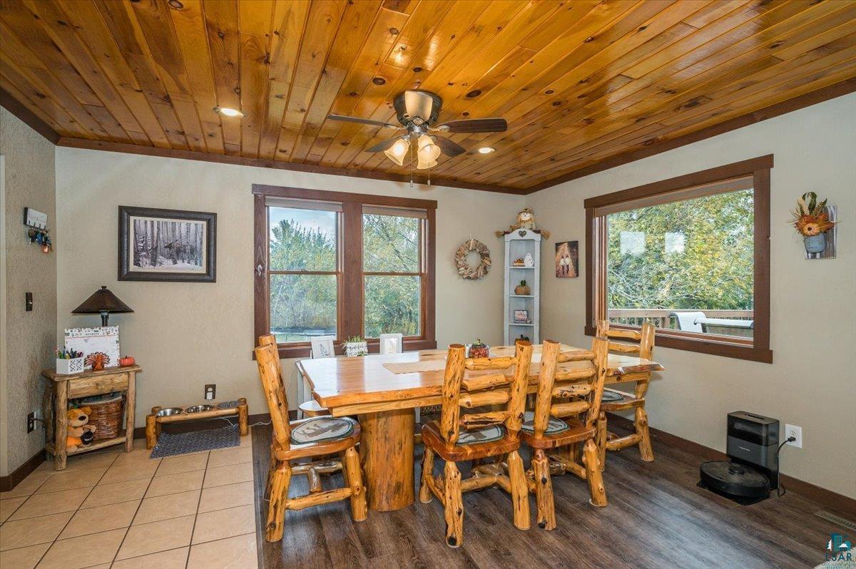 7702 East Rockmont Road Poplar, WI 54864 - Photo 9 of 22 Tiled dining area with wood ceiling and ceiling fan