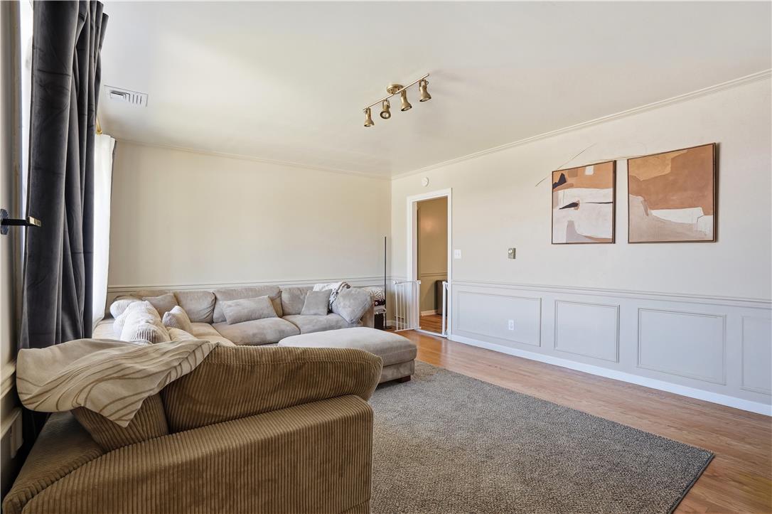 2918 Keystone Street Bethlehem, PA 18020 - Photo 5 of 54 A welcoming living area boasts hardwood flooring, wainscoting, and crown molding.