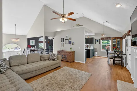 a living room with furniture and wooden floor