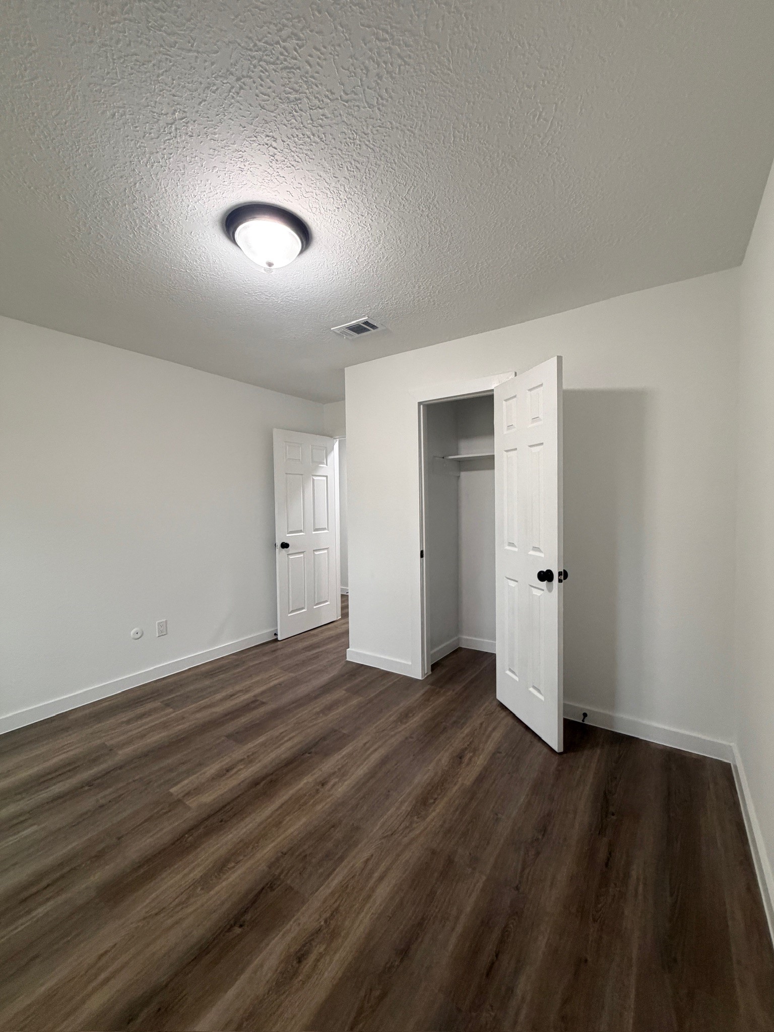 9806 Early Spring Drive Houston, TX 77064 - Photo 11 of 14 a view of an empty room with wooden floor and closet