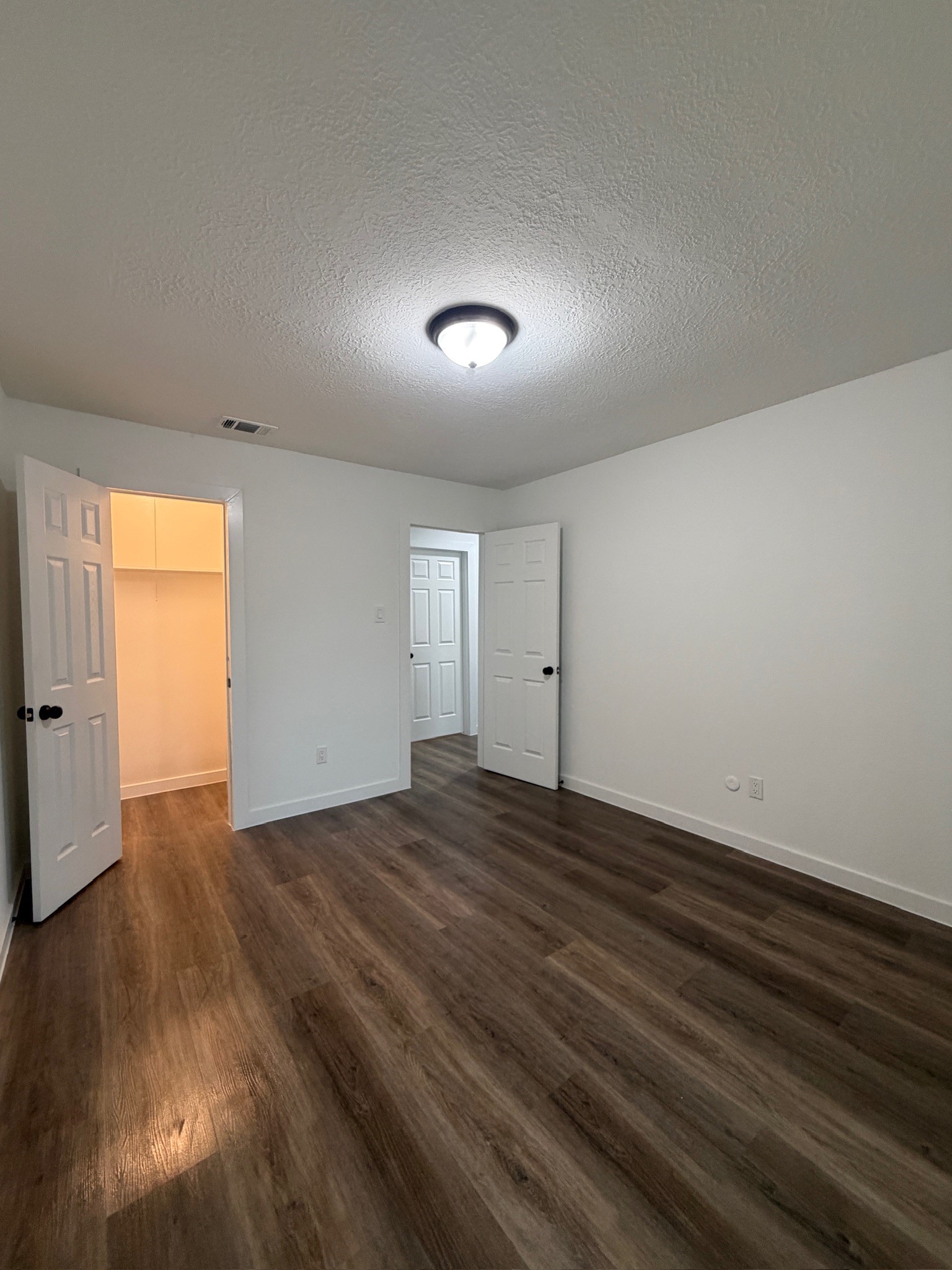 9806 Early Spring Drive Houston, TX 77064 - Photo 12 of 14 an empty room with wooden floor and windows