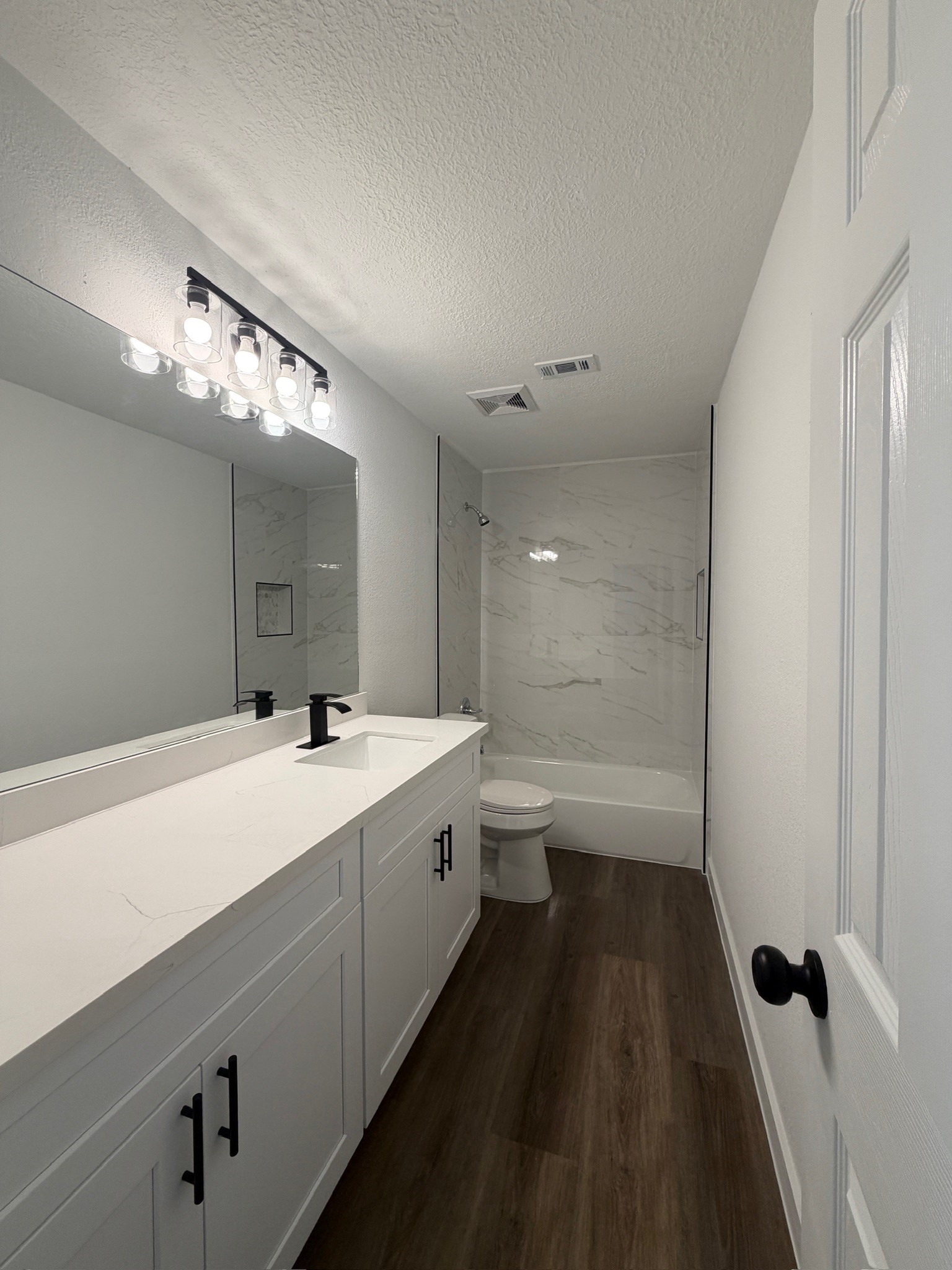 9806 Early Spring Drive Houston, TX 77064 - Photo 13 of 14 a bathroom with a double vanity sink a toilet and a mirror