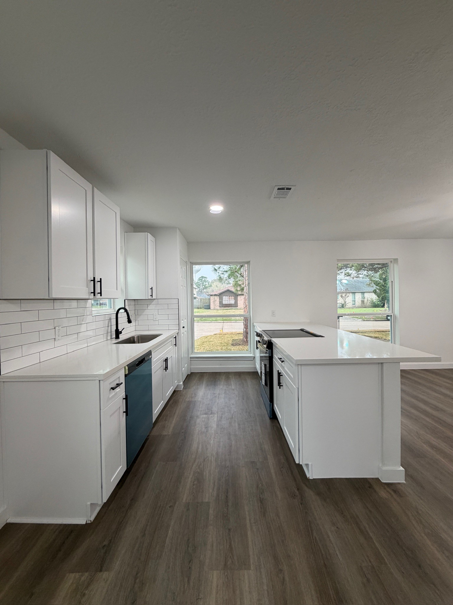 9806 Early Spring Drive Houston, TX 77064 - Photo 5 of 14 a large kitchen with a lot of counter space and wooden floor