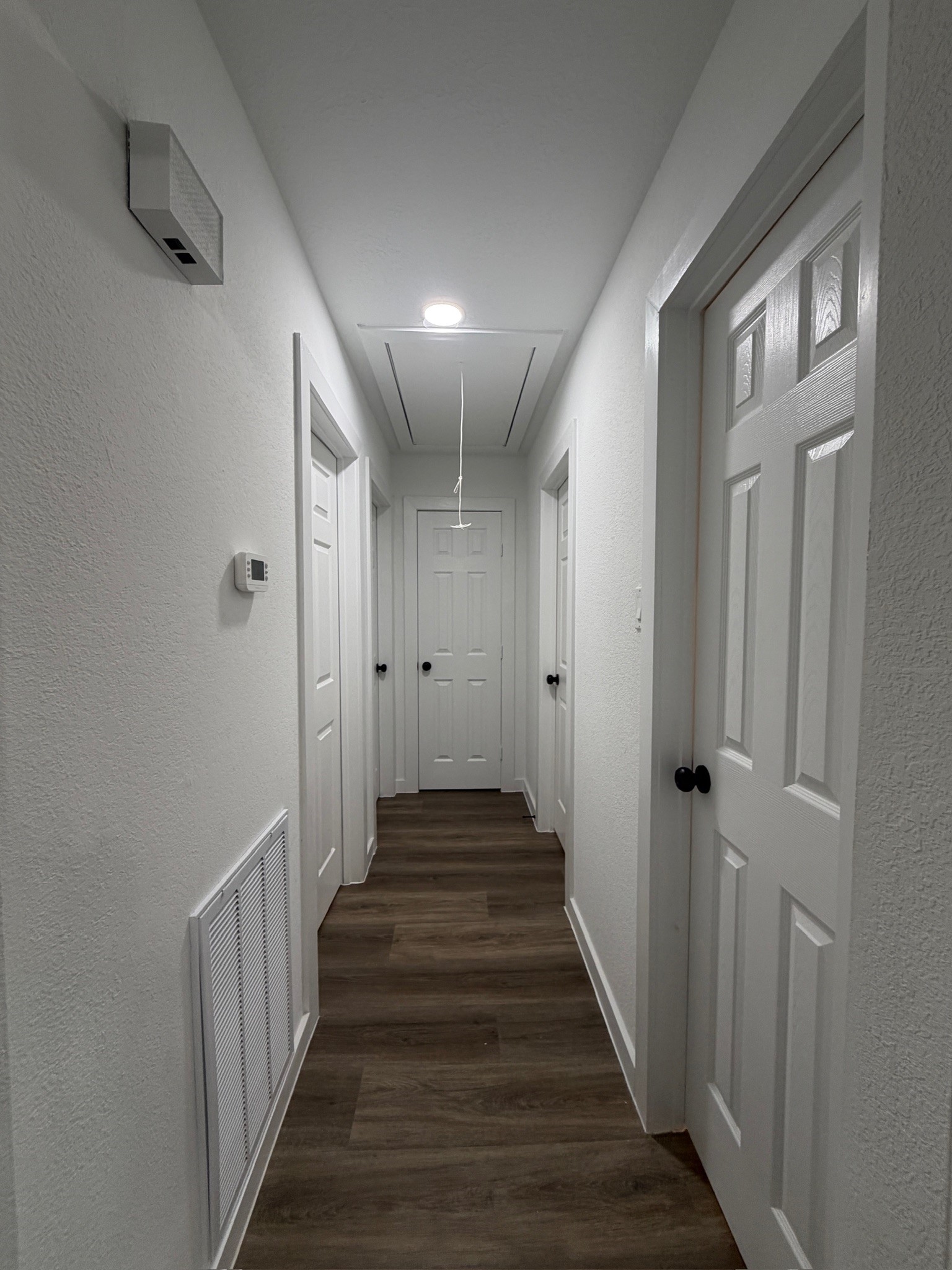 9806 Early Spring Drive Houston, TX 77064 - Photo 6 of 14 a view of a hallway with wooden floor and staircase