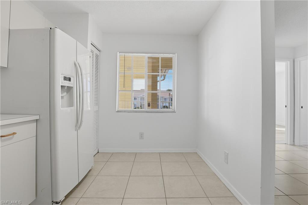 7762 Jewel Lane, Unit 201 Naples, FL 34109 - Photo 12 of 39 a view of an empty room with closet and a window