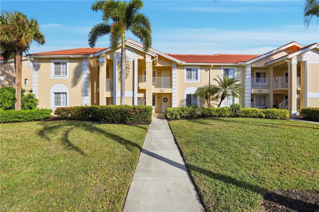 7762 Jewel Lane, Unit 201 Naples, FL 34109 - Photo 3 of 39 a front view of a house with swimming pool