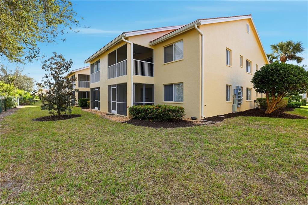 7762 Jewel Lane, Unit 201 Naples, FL 34109 - Photo 32 of 39 a view of a house with a yard