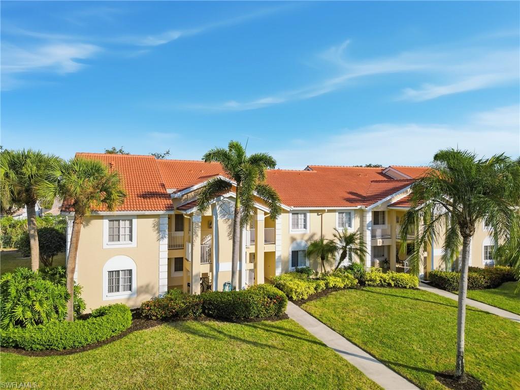 7762 Jewel Lane, Unit 201 Naples, FL 34109 - Photo 36 of 39 front view of a house with a yard