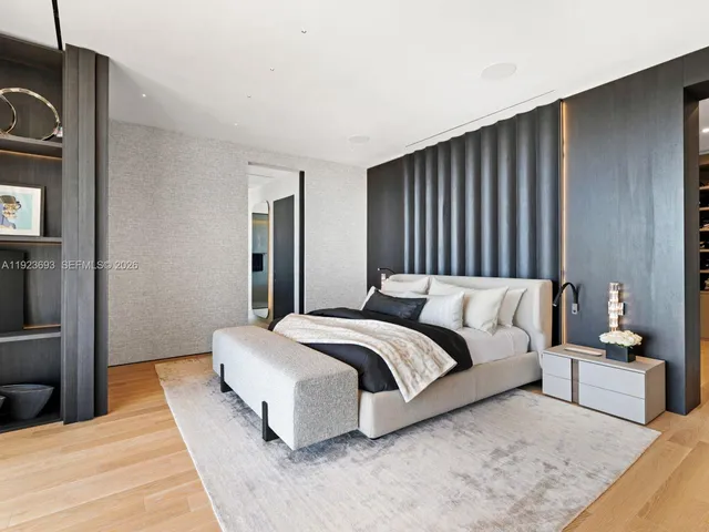 a bedroom with a bed and a night stand