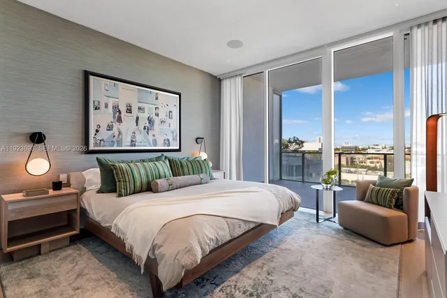 a bedroom with a bed and glass window