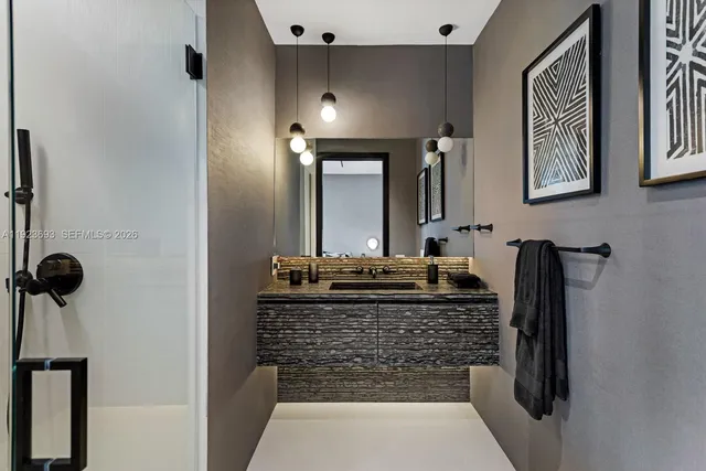 a bathroom with a granite countertop sink a vanity and mirror