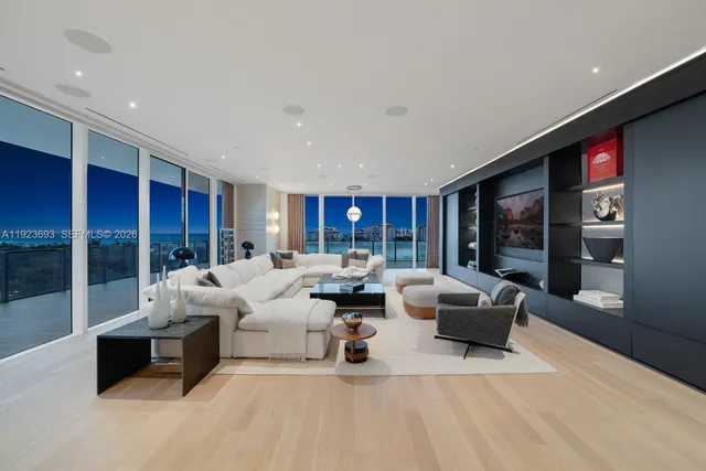 a bedroom with a large bed and a large window