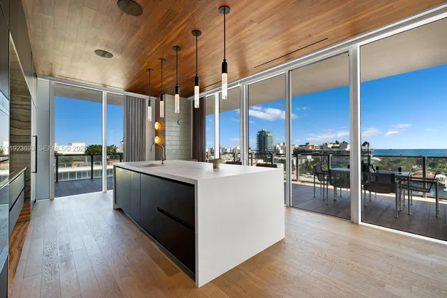 a large kitchen with stainless steel appliances kitchen island granite countertop a large counter top and stove