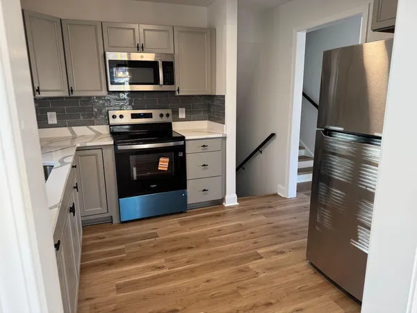 a kitchen with stainless steel appliances a refrigerator stove and microwave