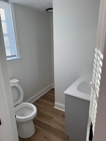 a bathroom with a toilet sink and mirror