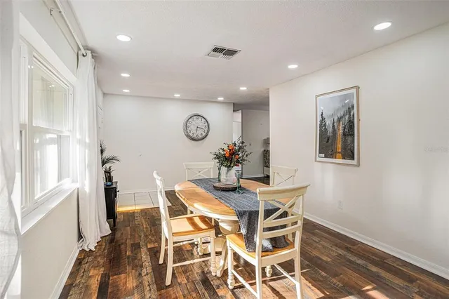 a view of a dining room with furniture and a chandelier