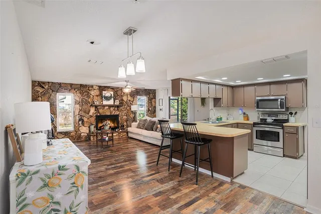 a open kitchen with stainless steel appliances granite countertop a stove and a refrigerator