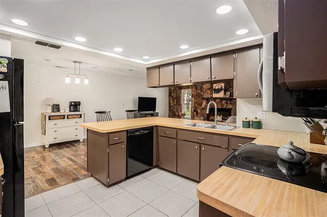 a kitchen with stainless steel appliances kitchen island granite countertop a sink and cabinets