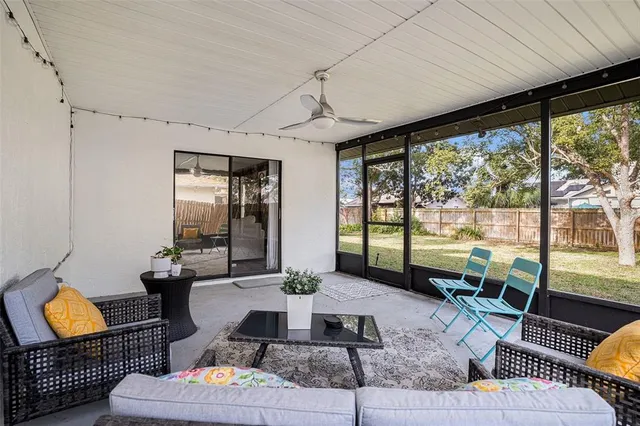 a living room with furniture and a floor to ceiling window
