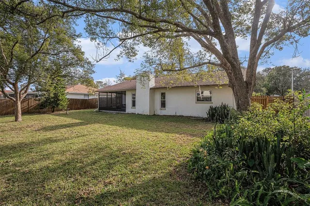 a front view of house with yard and trees