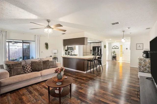 a living room with furniture or kitchen view and a wooden floor