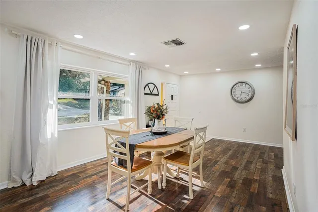 a view of a dining room with furniture window and wooden floor