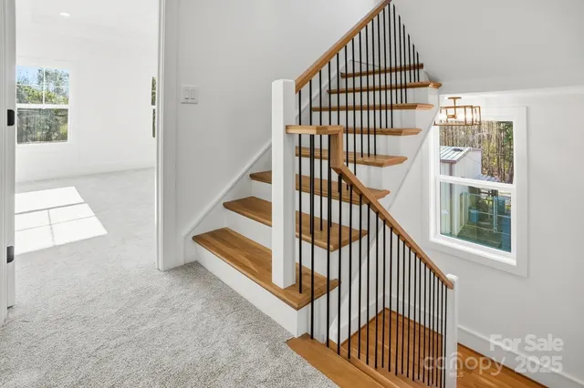a view of a hallway with wooden floor and entryway
