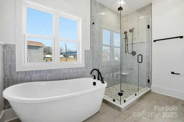 a bathroom with a bathtub and shower