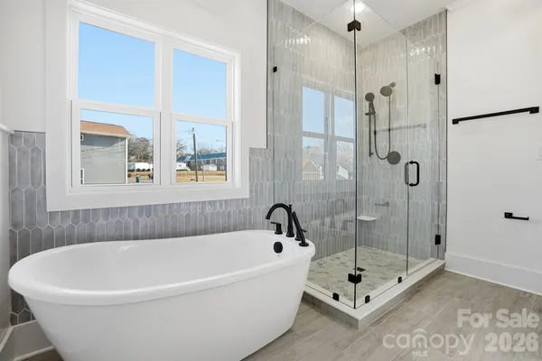 a bathroom with a bathtub and shower
