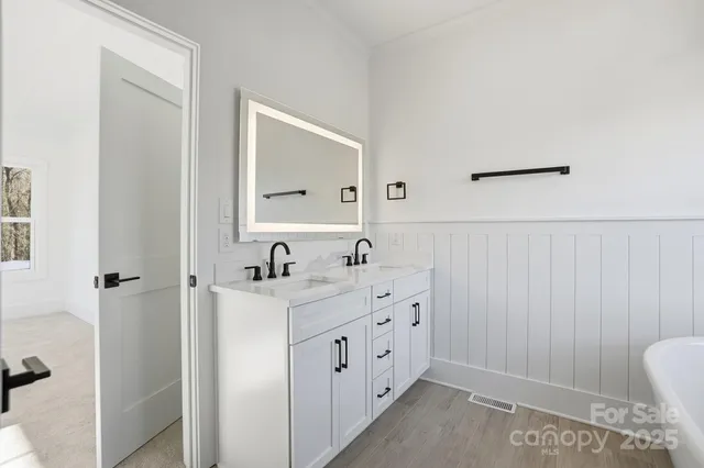 a bathroom with a double vanity sink mirror and double