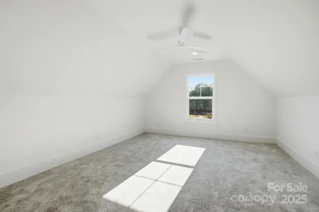 a bathroom with a granite countertop toilet sink and mirror
