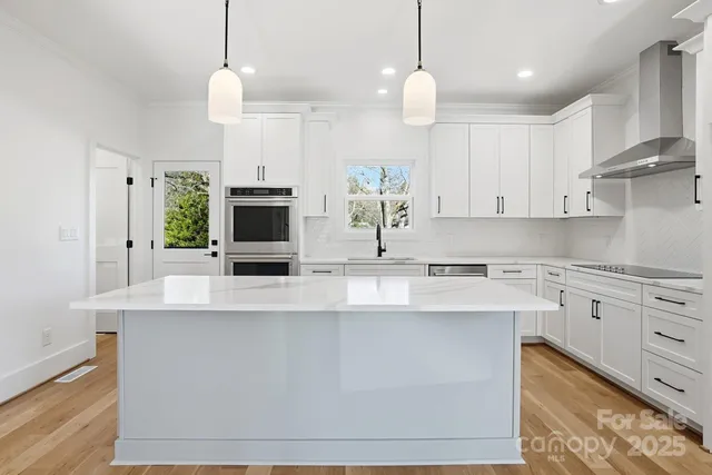 a kitchen with kitchen island white cabinets and white appliances