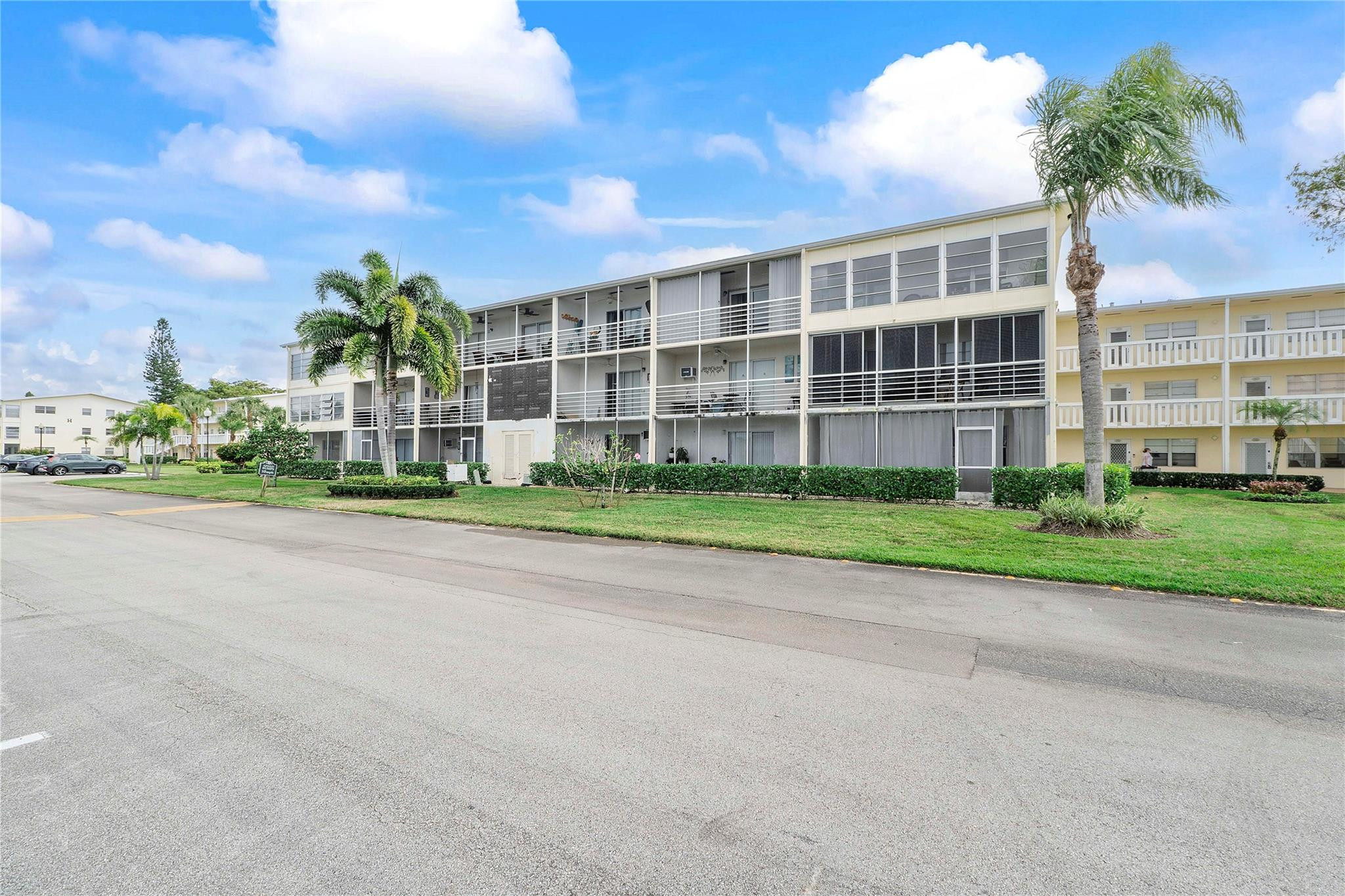 358 Dorset I, Unit 358 Boca Raton, FL 33434 - Photo 11 of 12 a view of a building with a yard