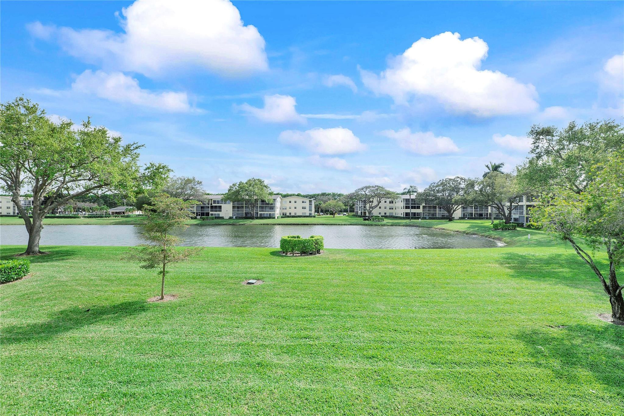 358 Dorset I, Unit 358 Boca Raton, FL 33434 - Photo 2 of 12 a view of a lake with a big yard