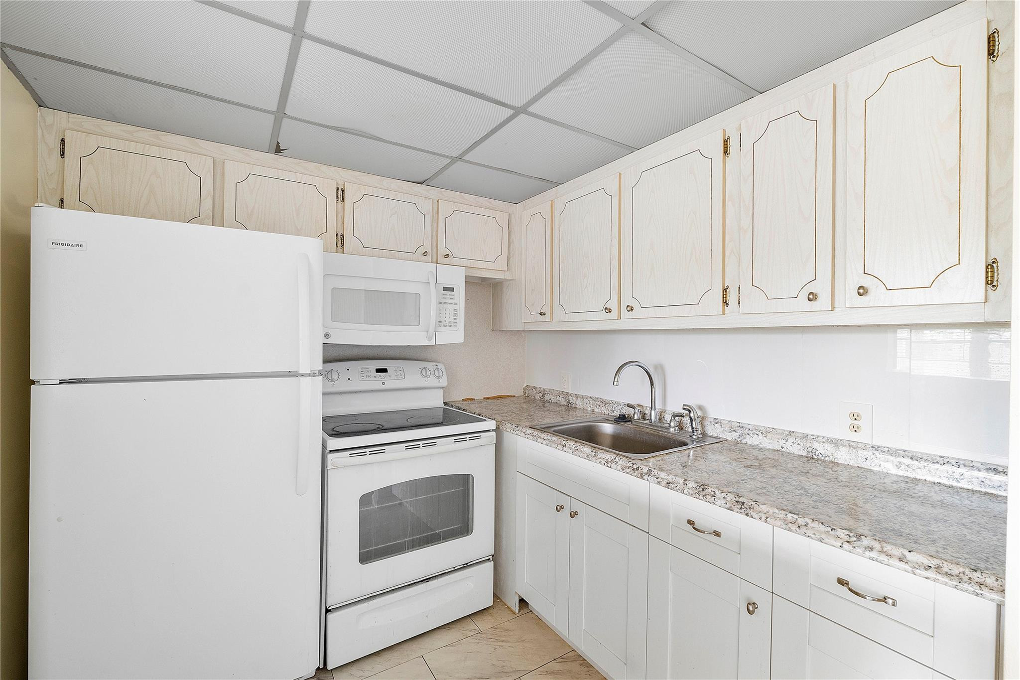 358 Dorset I, Unit 358 Boca Raton, FL 33434 - Photo 3 of 12 a white refrigerator freezer sitting inside of a kitchen