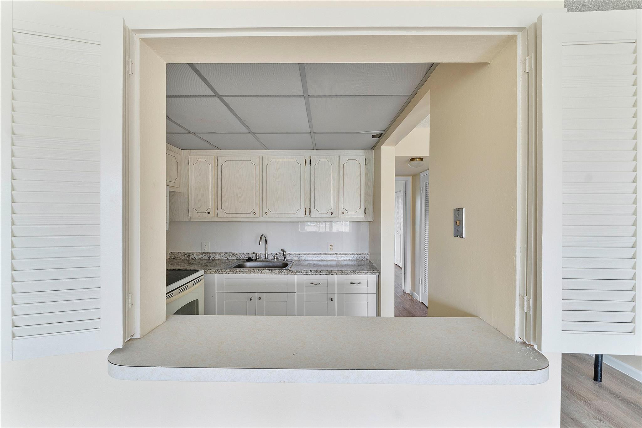 358 Dorset I, Unit 358 Boca Raton, FL 33434 - Photo 4 of 12 a kitchen with a sink a stove and cabinets